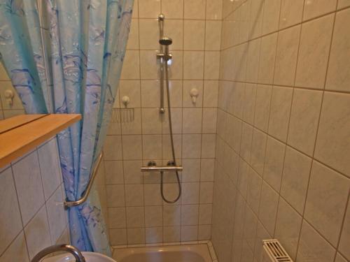 a shower with a blue shower curtain in a bathroom at Charmant apt avec accès indépendant, terrasse, proche Épinal et activités culturelles - FR-1-589-138 in Hagécourt