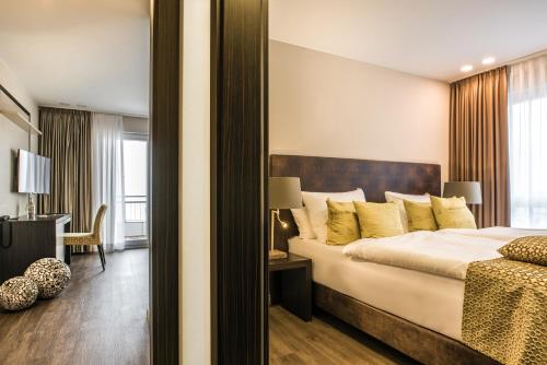a bedroom with a large bed and a mirror at Strandhotel Luv in Timmendorfer Strand