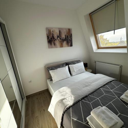 a bedroom with a bed and a window at Apartment Athens 2 in Sombor