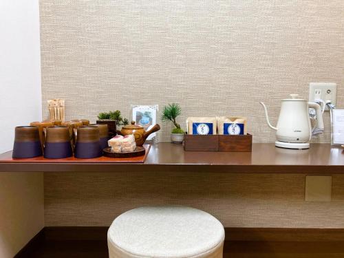 a counter with a table with a coffee maker and other items at Misono no Oyado I 美園のおやど い #IO1 in Wakayama