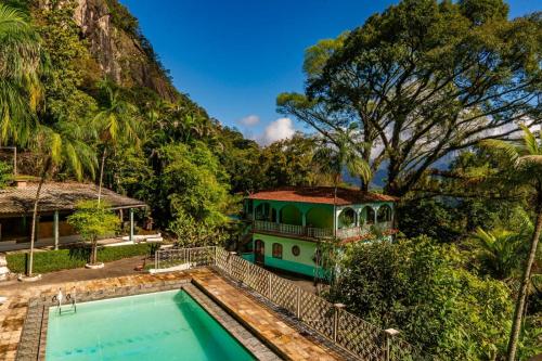um bonde estacionado ao lado de uma casa com piscina em Refúgio na Serra de Petrópolis simples e acolhedor em Petrópolis