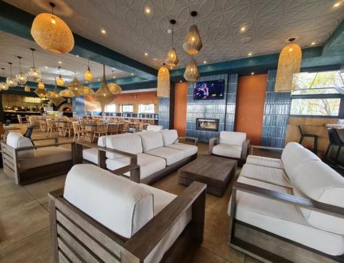 a lobby with white couches and a bar at The Blyde blue lagoon in Pretoria