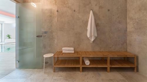 a bathroom with a shower and a wooden table at Villa Montefalcone 8 by Marche Holiday Villas in Acqualagna