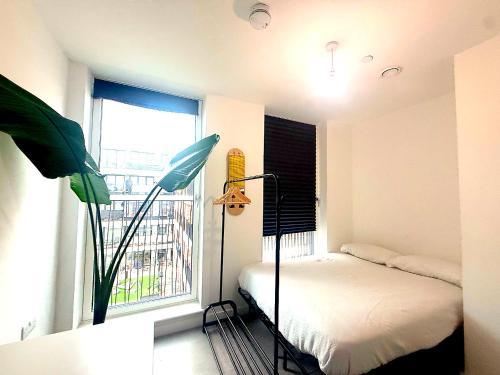 a small bedroom with a bed and a window at Modern & charming home in Hackney in London