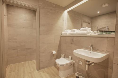 a bathroom with a white toilet and a sink at Royal Whitby in Whitby