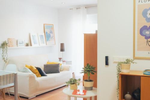 a living room with a white couch and a table at Blanca Mar in Barrio-Mar
