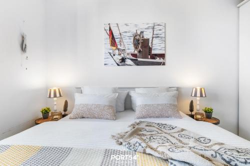 a bedroom with a bed with a picture on the wall at Ferienwohnung Albatros Olpenitz in Olpenitzdorf