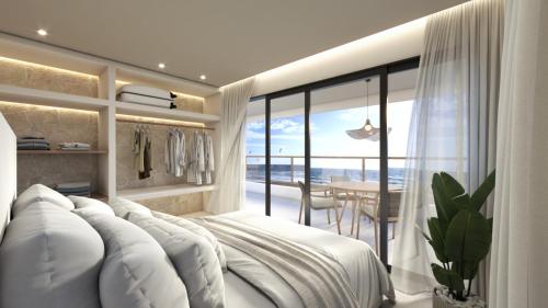 a bedroom with a white bed with a view of the ocean at Windtown Beach Hotel in Cumbuco