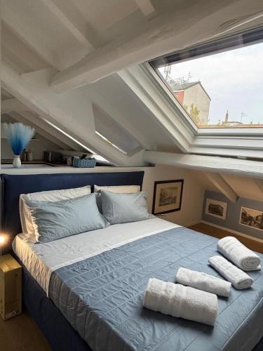 a bedroom with a large bed with towels on it at La piccola soffitta Azzurra in Milan
