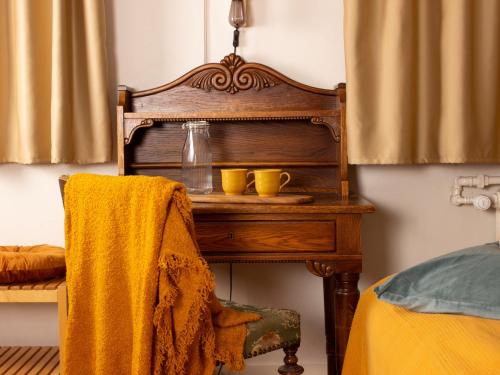 a wooden table with two yellow cups on it at Eric the Red Guesthouse in Reykjavík