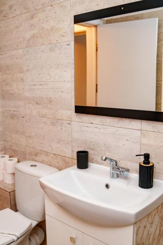 a bathroom with a white sink and a mirror at DREAMS ESCAPE 2 in Craiova