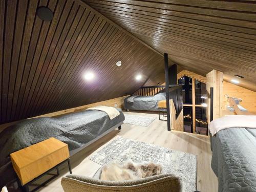 a room with two bunk beds and a couch at Villa Martta, Yllas, Lapland Hideaway Near Trails in Äkäslompolo