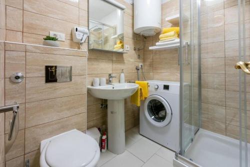 a bathroom with a sink and a washing machine at House Igor in Ledenice