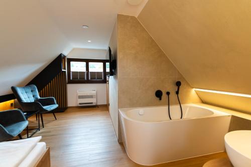 a bathroom with a white tub in a room at Husí plácek s vinným sklepem a terasou in Dolní Věstonice