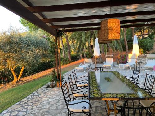 a dining table and chairs under a pergola at Villa Star in Capo D'Arco