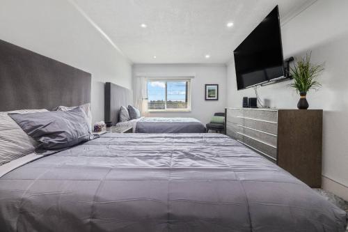 a bedroom with a large bed and a flat screen tv at Copperheads 14th Hole Tee Box View in Lake Shore Estates