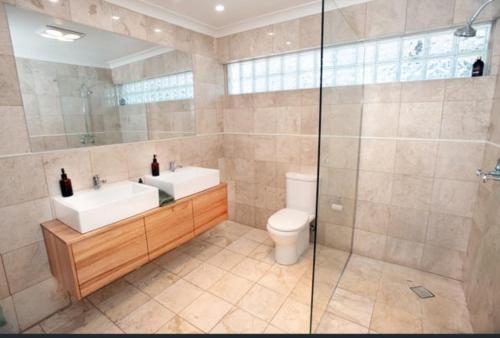 a bathroom with a toilet and a sink and a shower at The Pond House Trentham in Trentham