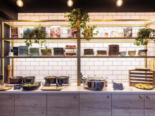 uma cozinha com panelas e frigideiras num balcão em Mercure Bordeaux Centre Ville em Bordéus