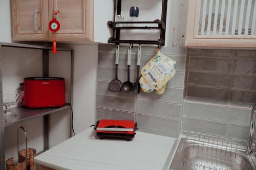 a kitchen with a red appliance on a counter at Bridge View Cottage in Podhokhórion