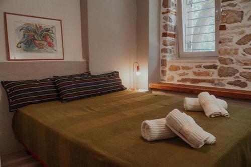 a bedroom with a bed with two pillows on it at Bridge View Cottage in Podhokhórion