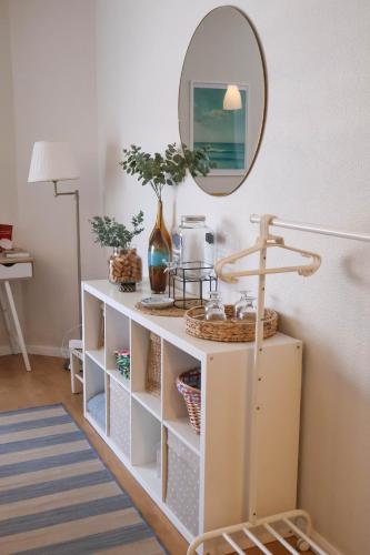 a white cabinet with a mirror in a room at Areia StayInn Beach Apartment in Árvore