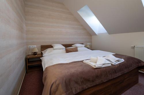 a bedroom with a large bed with towels on it at Apartment No.28 Jasná in Belá