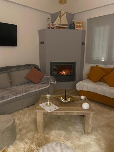 a living room with a couch and a fireplace at Dryades in Elati Zagori