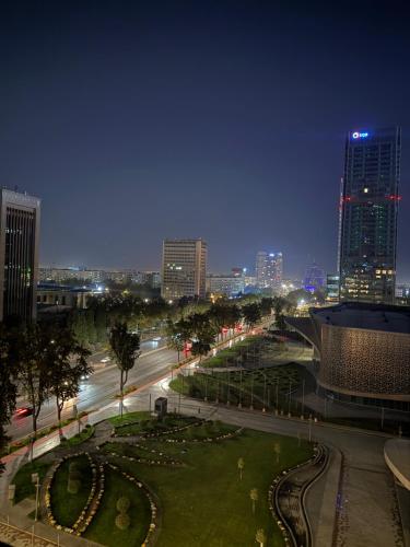 a view of a city at night with buildings at Nest one, Tashkent City in Tashkent