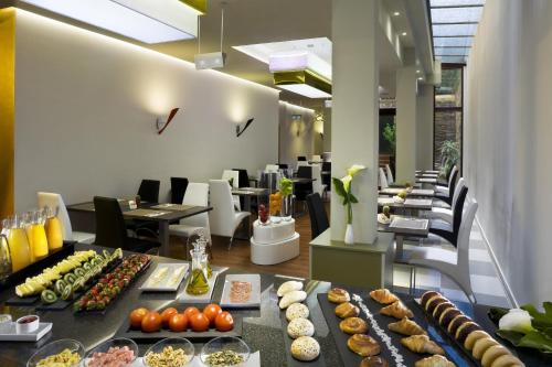 a buffet line with many different types of food at NH Ourense in Ourense