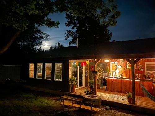 a small house with a porch at night at Angies Country Cabins -Off Grid Cabins with shared hot tub access Primitive outhouses Please note This is camping Open year round in Cassadaga