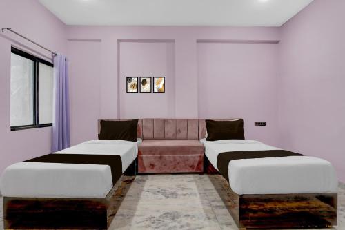 a room with two beds and a couch at Hotel O G9 in Akolia