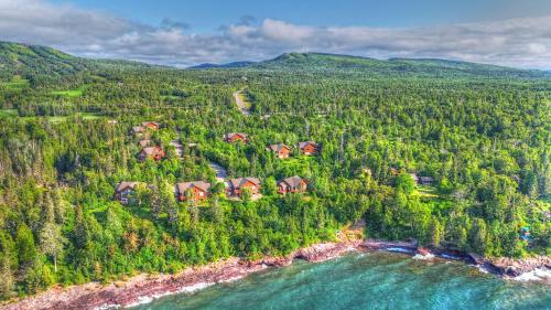 an aerial view of a house on the shore of a river at Poplar River Condos in Lutsen