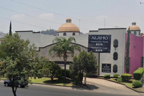 a building with a sign in front of it at motel alamo in Guadalajara
