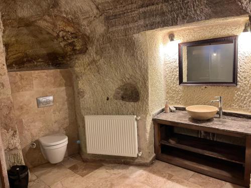 a bathroom with a sink and a toilet at Cosy cave suit in Ürgüp
