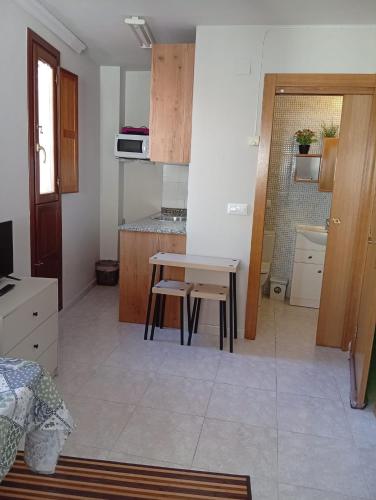 a kitchen with a table and a small table and chairs at Coqueto Estudio 2 in Ezcaray