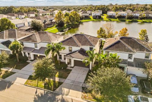 an overhead view of a row of houses with a river at Sunny Stay in Orlando - 6BR Home with Pool! in Kissimmee