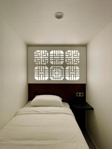 a bedroom with a bed and a window at Hotel Myeongdong Station in Seoul
