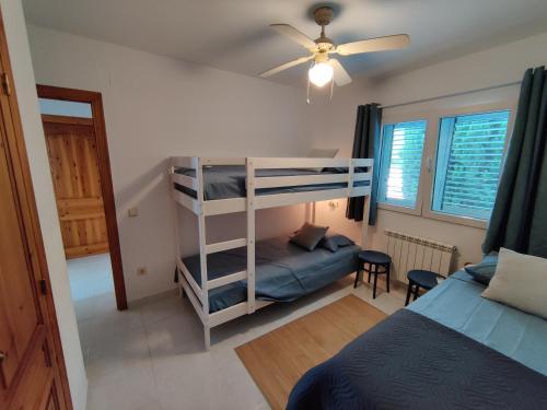 a bedroom with two bunk beds and a bed at Villa França Air conditioned villa with sea view, WiFi, and private pool in Alcossebre