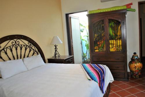 a bedroom with a bed and a dresser with stained glass at Casa Mar de Cortez in Loreto