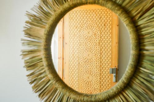 a reflection of a door in a mirror at Dar Iziki Separate Apartments in Sidi Kaouki