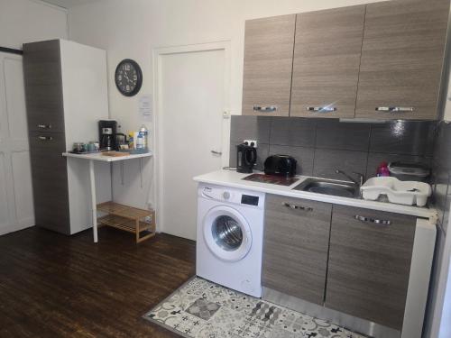 a kitchen with a washing machine and a sink at Number 22 - Le Dorat - Apartment One with garden & free parking in Le Dorat