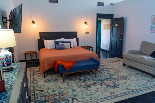 a bedroom with a bed and a couch at Sunset Oaks Retreat Events, Farm Animals & Views in Saint Jo