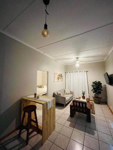 a living room with a table and a couch at Lily Palms Rest in Tzaneen