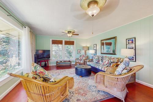 a living room with a couch and chairs at Hamakua Hale Ohana Country Retreat in Papaikou