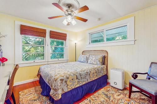 a bedroom with a bed and a ceiling fan at Hamakua Hale Ohana Country Retreat in Papaikou