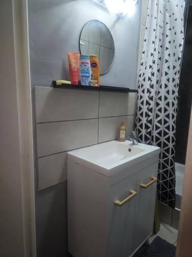 a bathroom with a sink and a mirror at Number 22 - Le Dorat - Apartment 3 with garden & free parking in Le Dorat