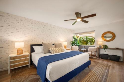 a bedroom with a bed and a ceiling fan at Modern studio, AC, king bed, private lanai in Princeville
