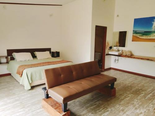 a bedroom with a bed and a bench in it at Green Lodge Eco Life in Florianópolis