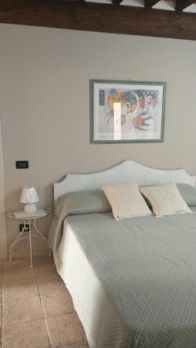a bedroom with a bed and a side table at La Libellula in Capannoli