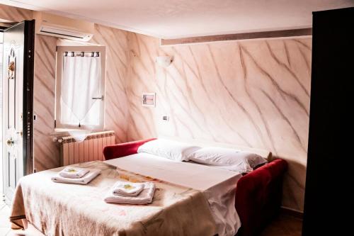 a bedroom with a bed with two towels on it at Studio apartment in Rome with a pool in Colonna